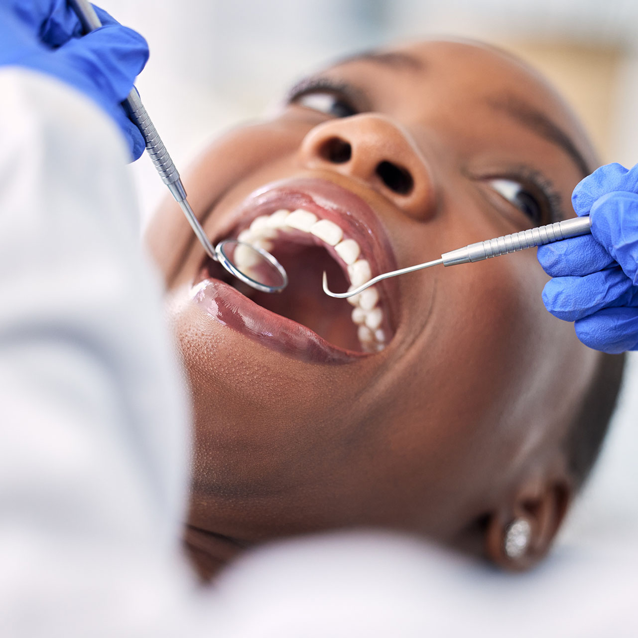 A dentist examining a patient's gums
